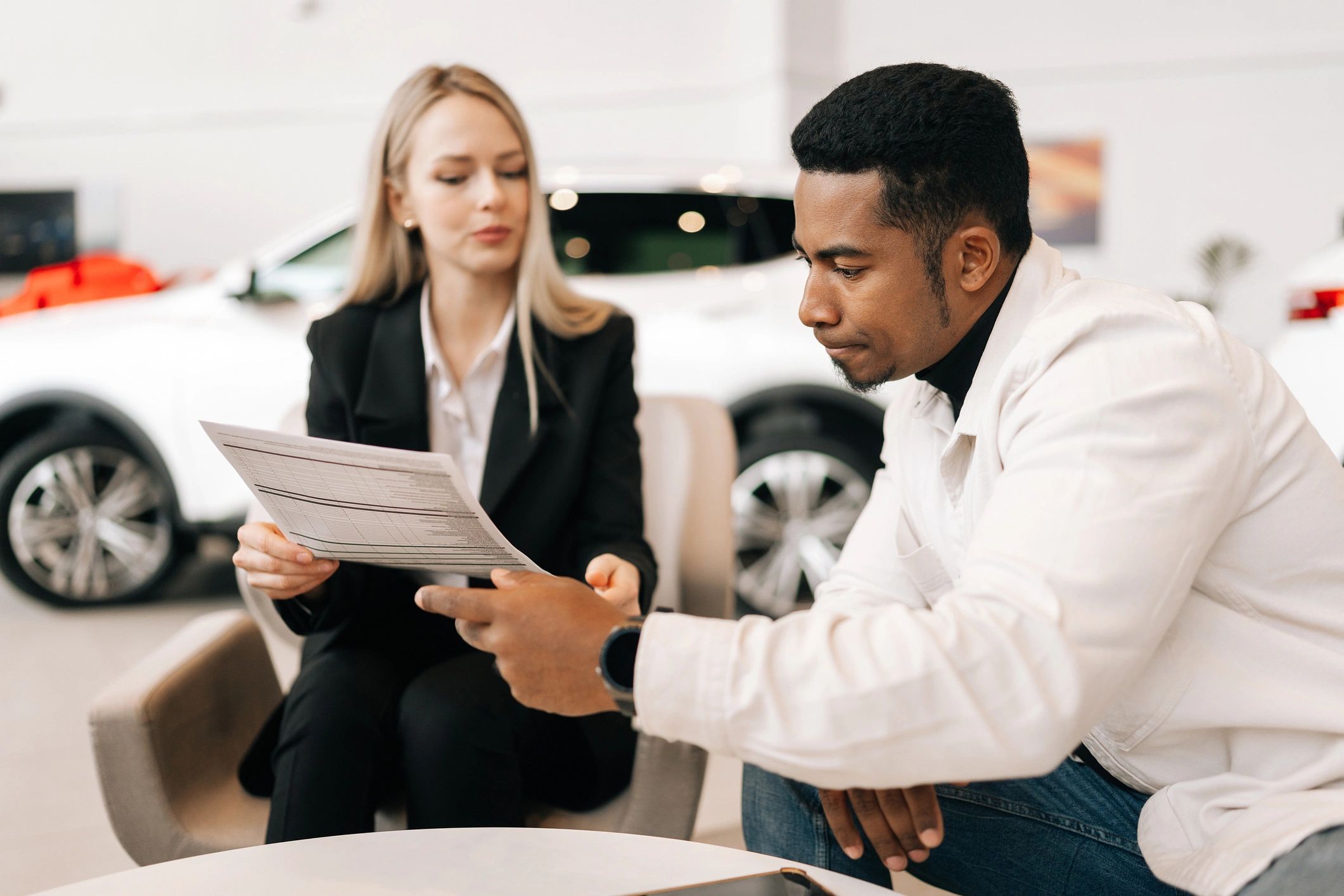 Insurance consultation with client reviewing auto coverage