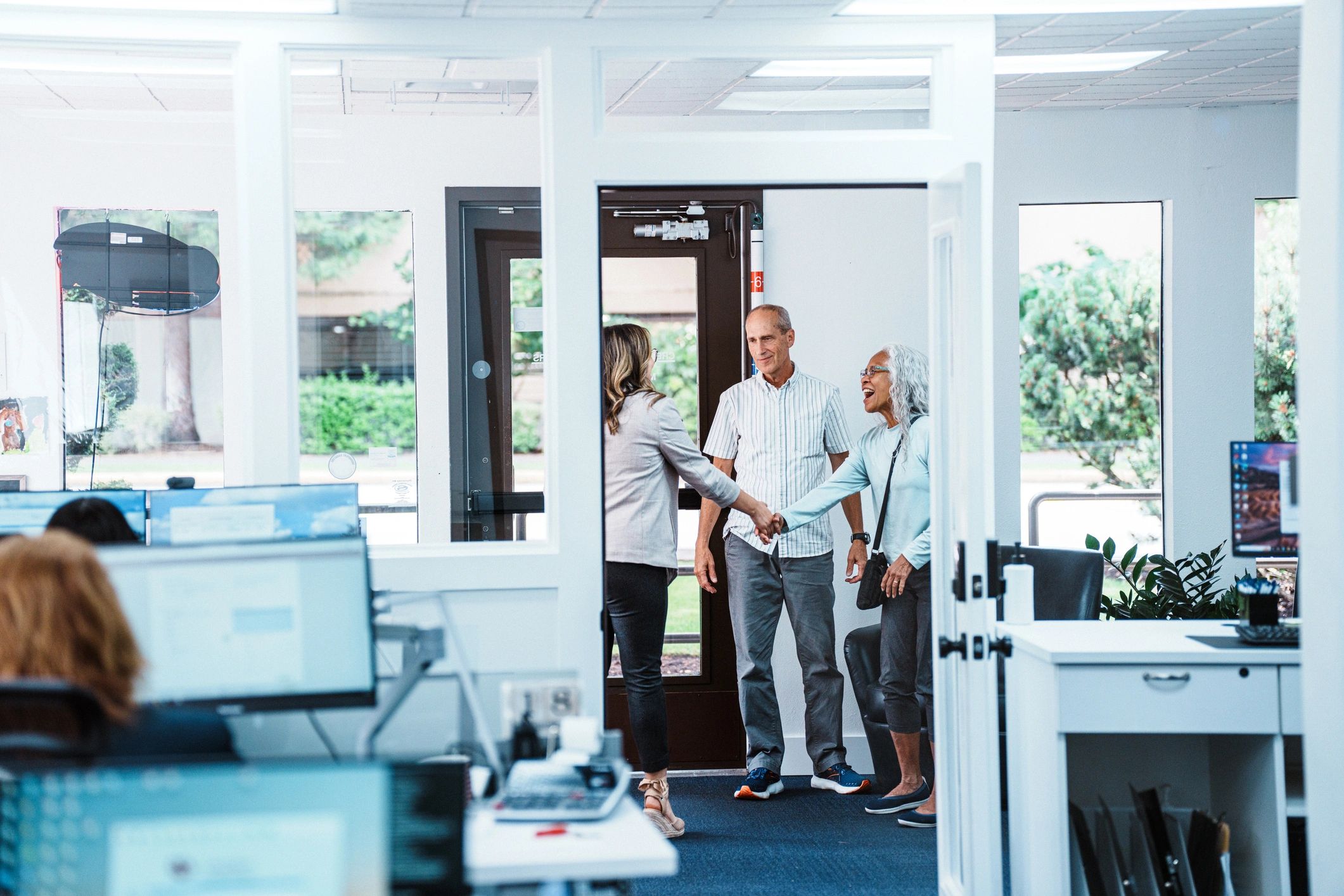 Clients greeting financial services professional